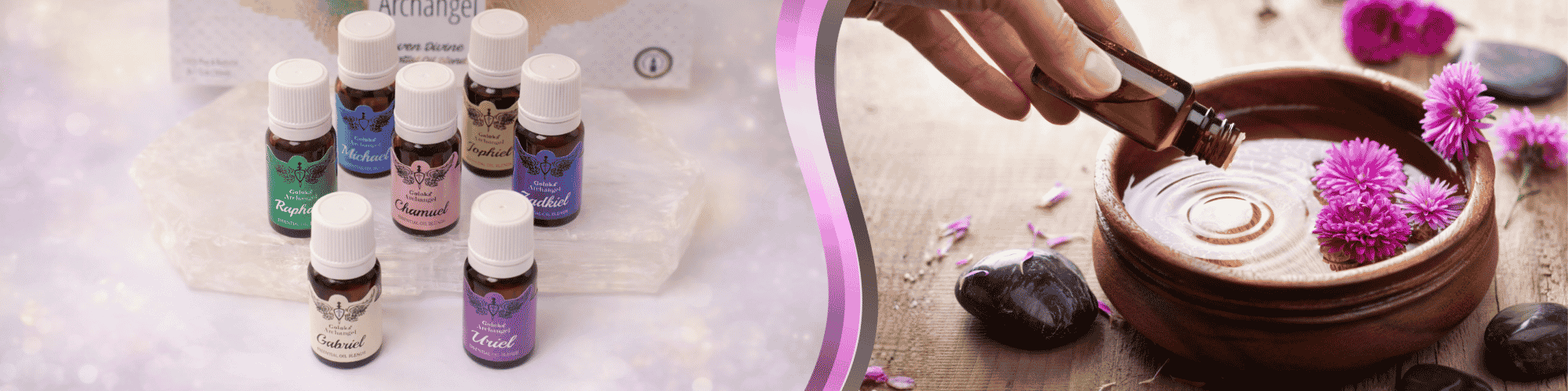 Essential oil bottles displayed on the left, with essential oil being poured into a decorative bowl accented by pink flowers and polished stones.